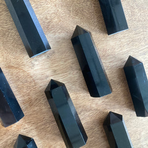 black obsidian crystal towers on a wooden surface